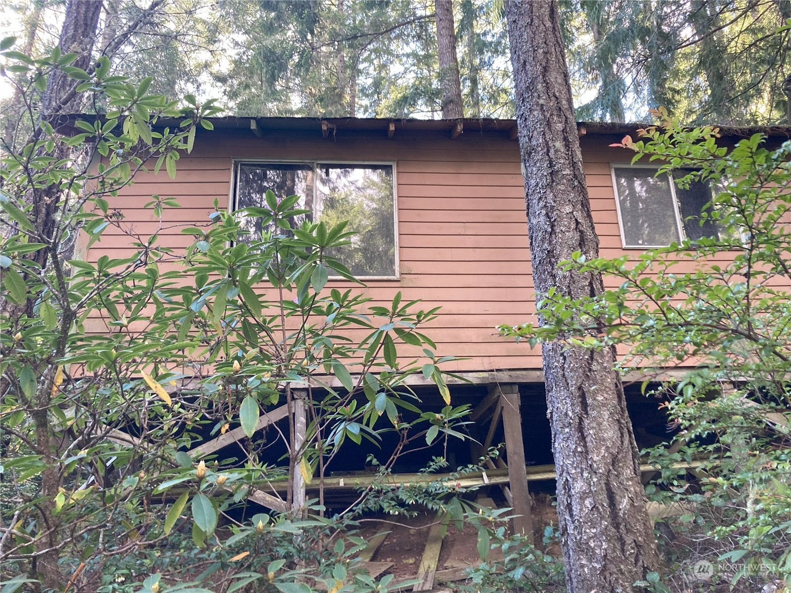 a view of house with backyard and sitting area