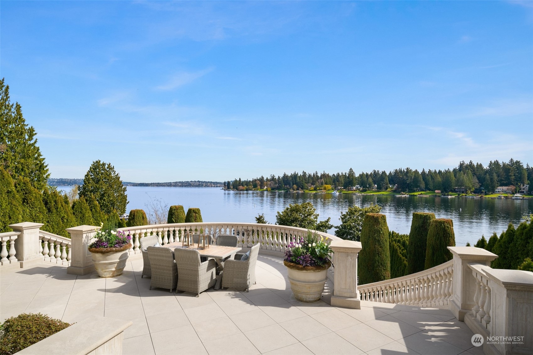 a view of a lake with a table and chairs