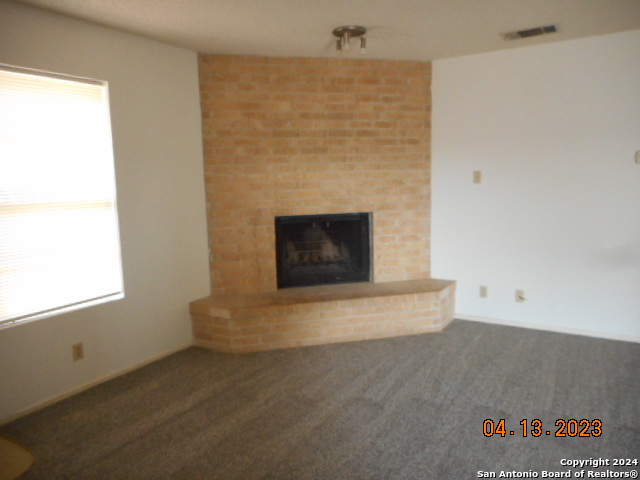 an empty room with a fireplace