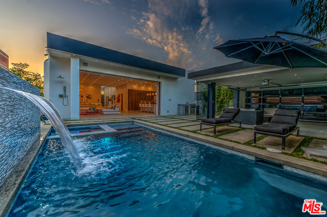 a view of a backyard with sitting area