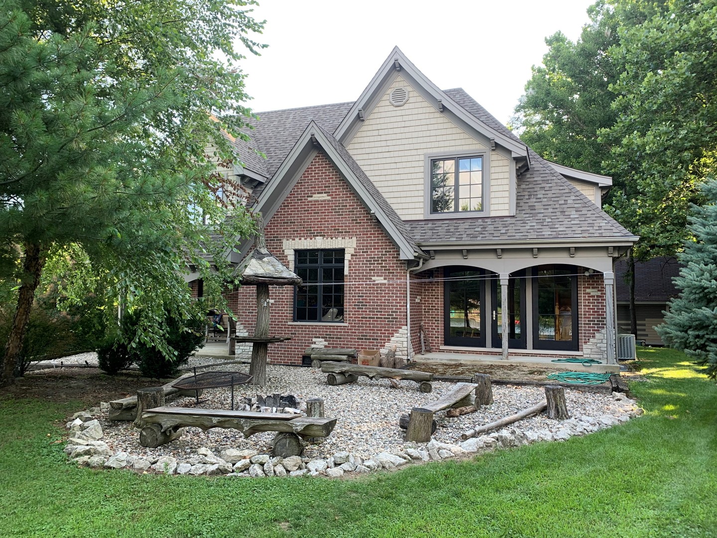 a front view of a house with a yard table and chairs