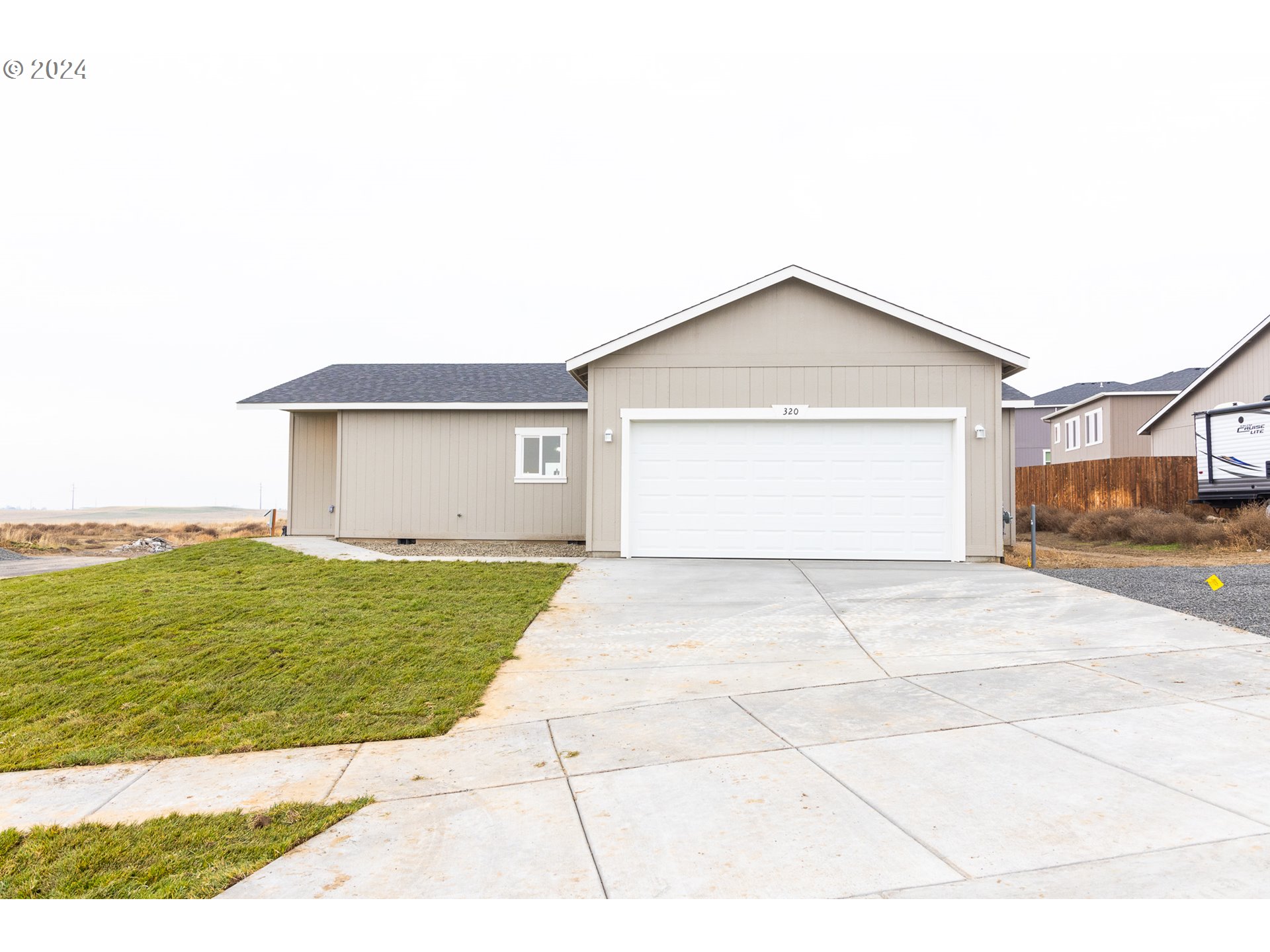 a view of a house with a yard and garage