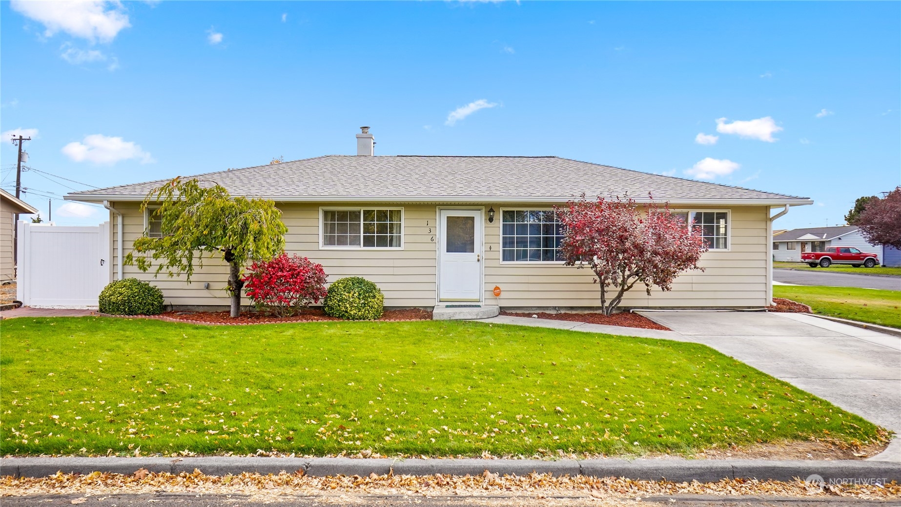 a view of a house with a yard and a garage