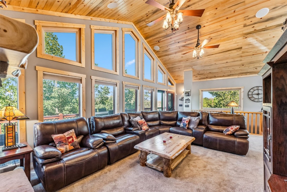 a living room with furniture ceiling fan and a rug