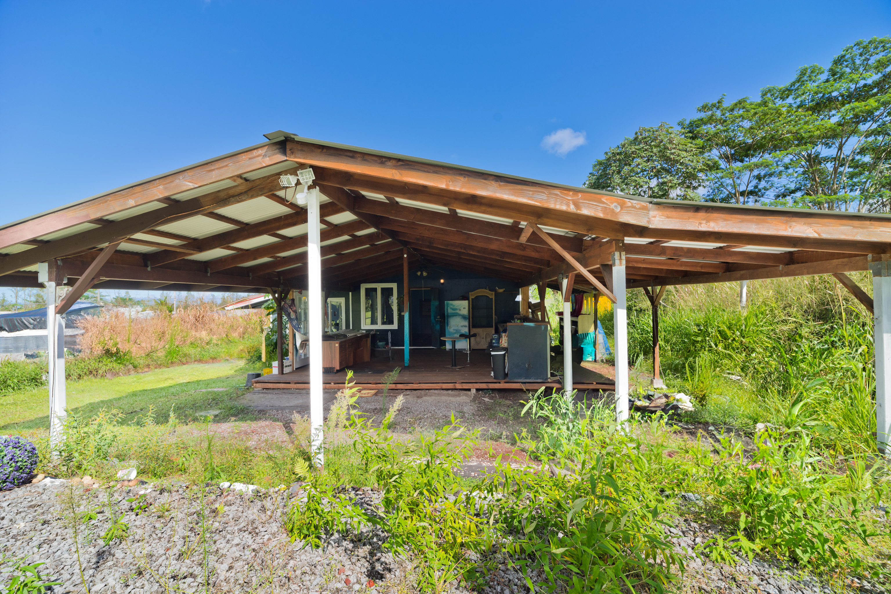 a view of a patio with table and chairs under an umbrella