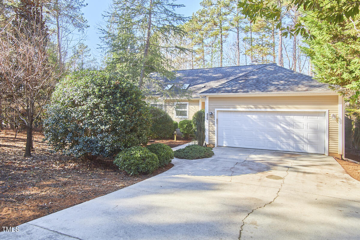 a view of a house with a yard and garage