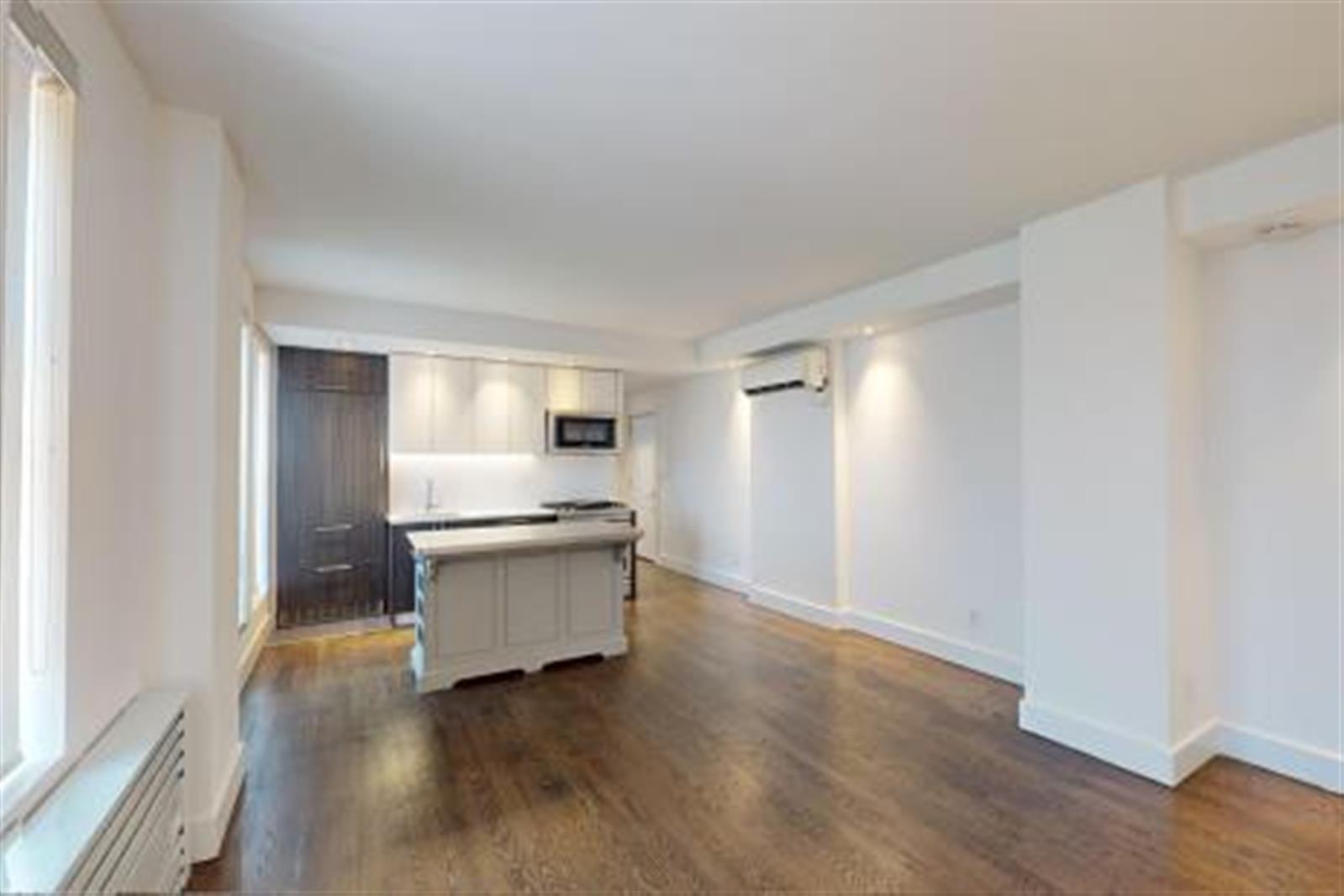 a room with a wooden floor and white walls