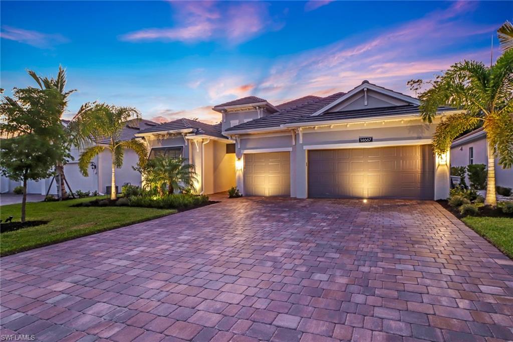 a view of a house with a yard and a garage