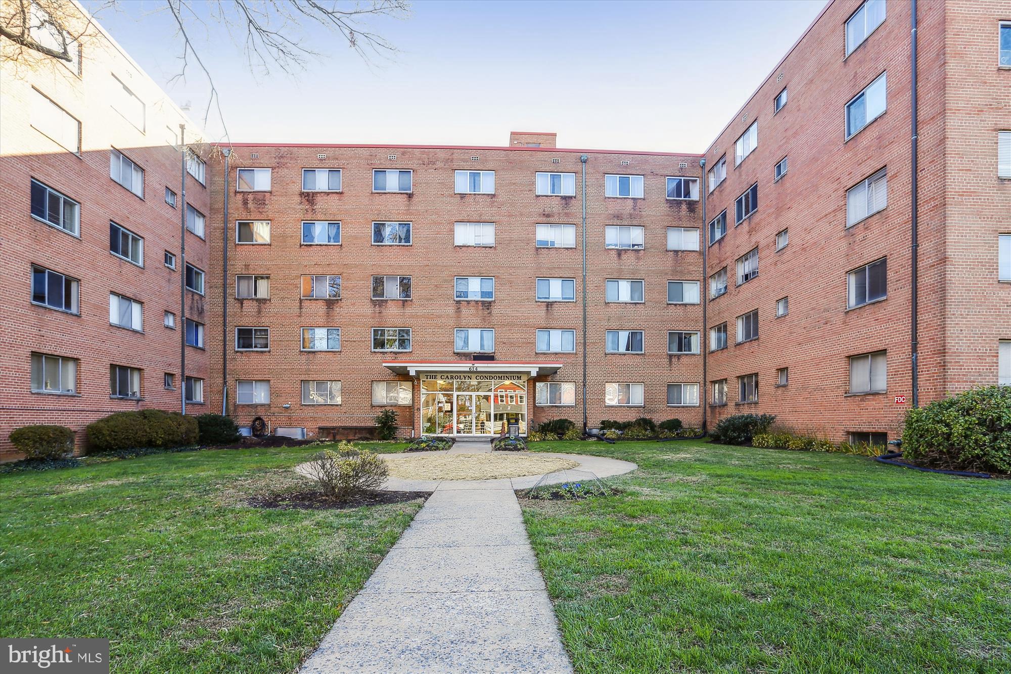 a large building with a yard in front of it