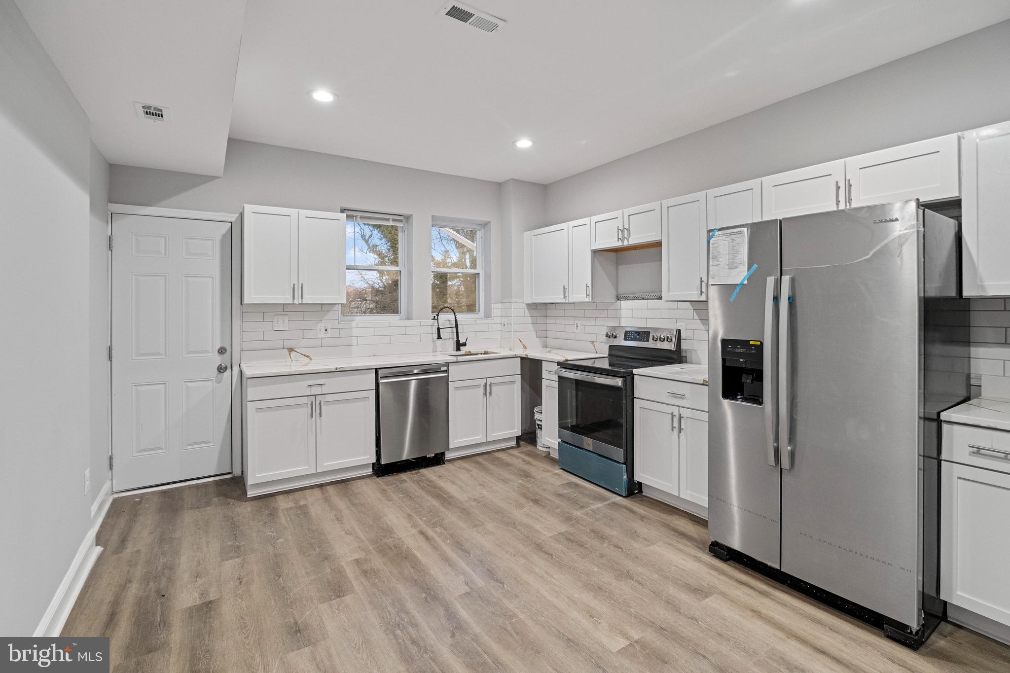 a kitchen with a white cabinets and stainless steel appliances