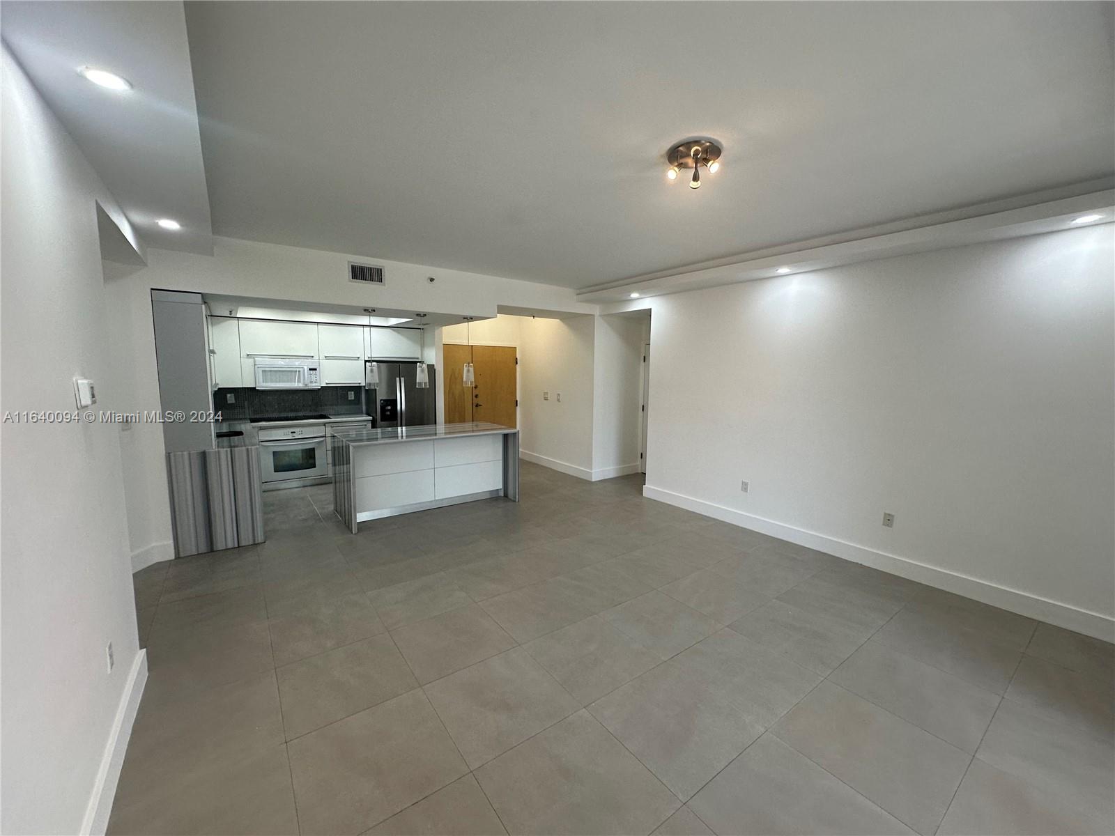 a view of a livingroom with a kitchen