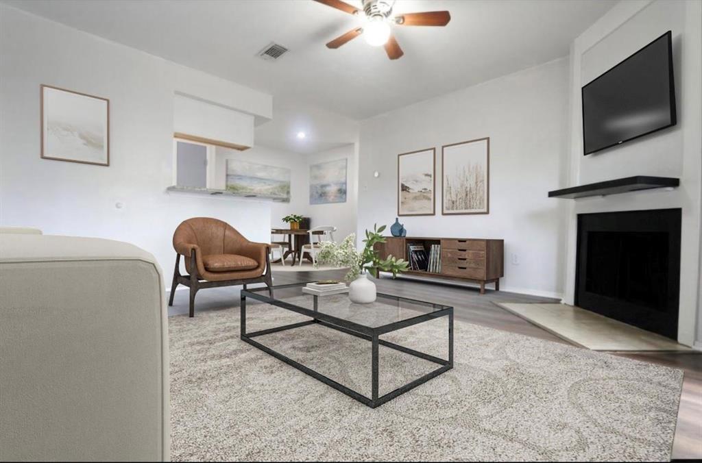 a living room with furniture a flat screen tv and a fireplace