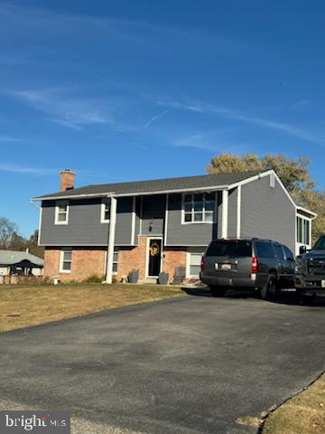 a view of house and car parked in front of house