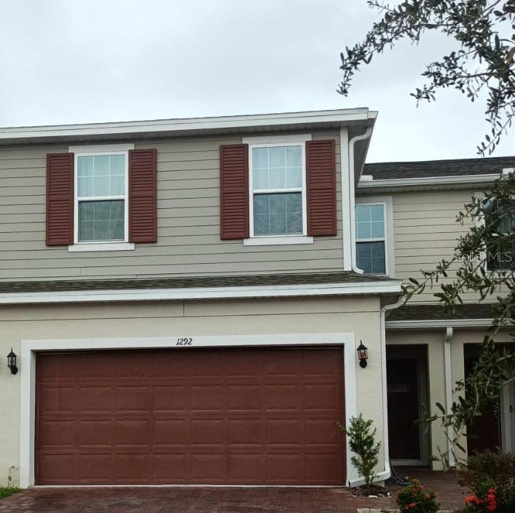 a front view of a house with garage