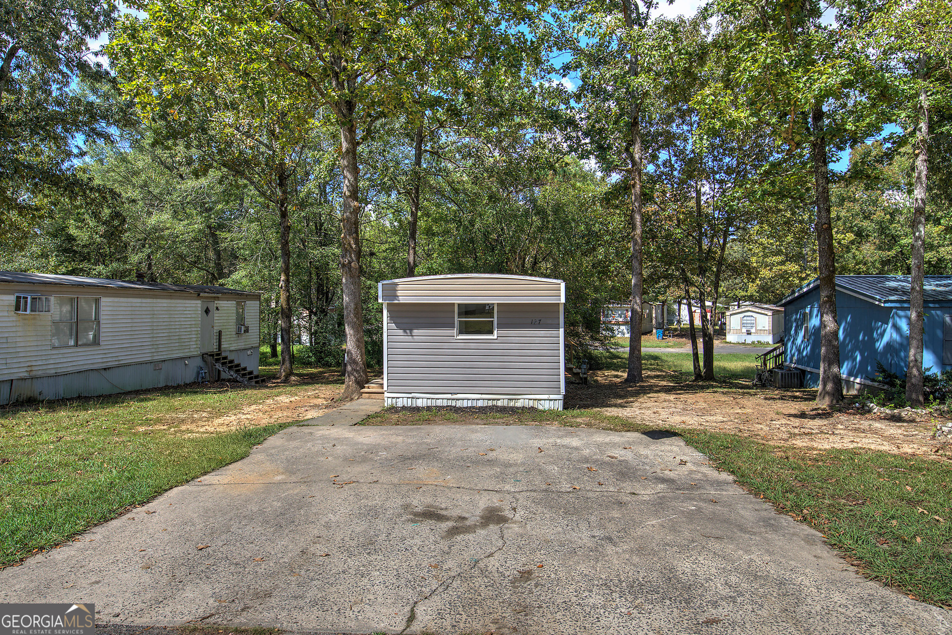 a view of a house with a yard and garage