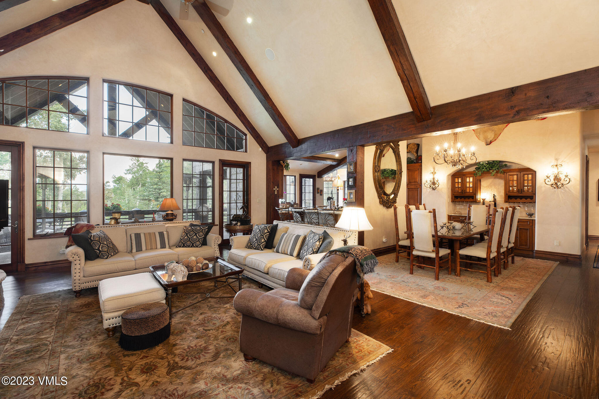 a living room with furniture and large windows