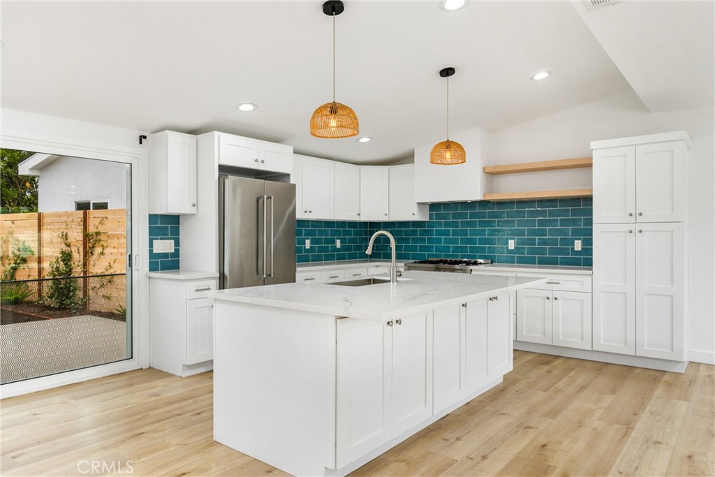 a kitchen with cabinets and wooden floors