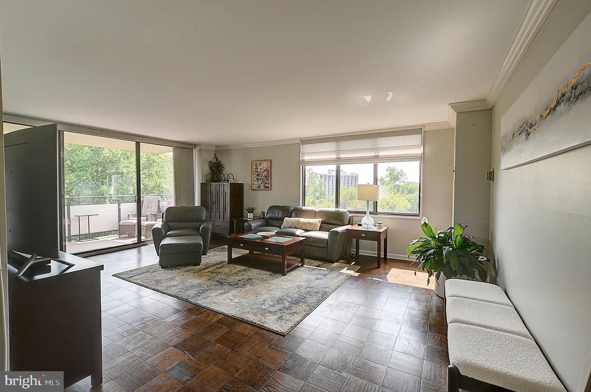 a living room with furniture and large windows