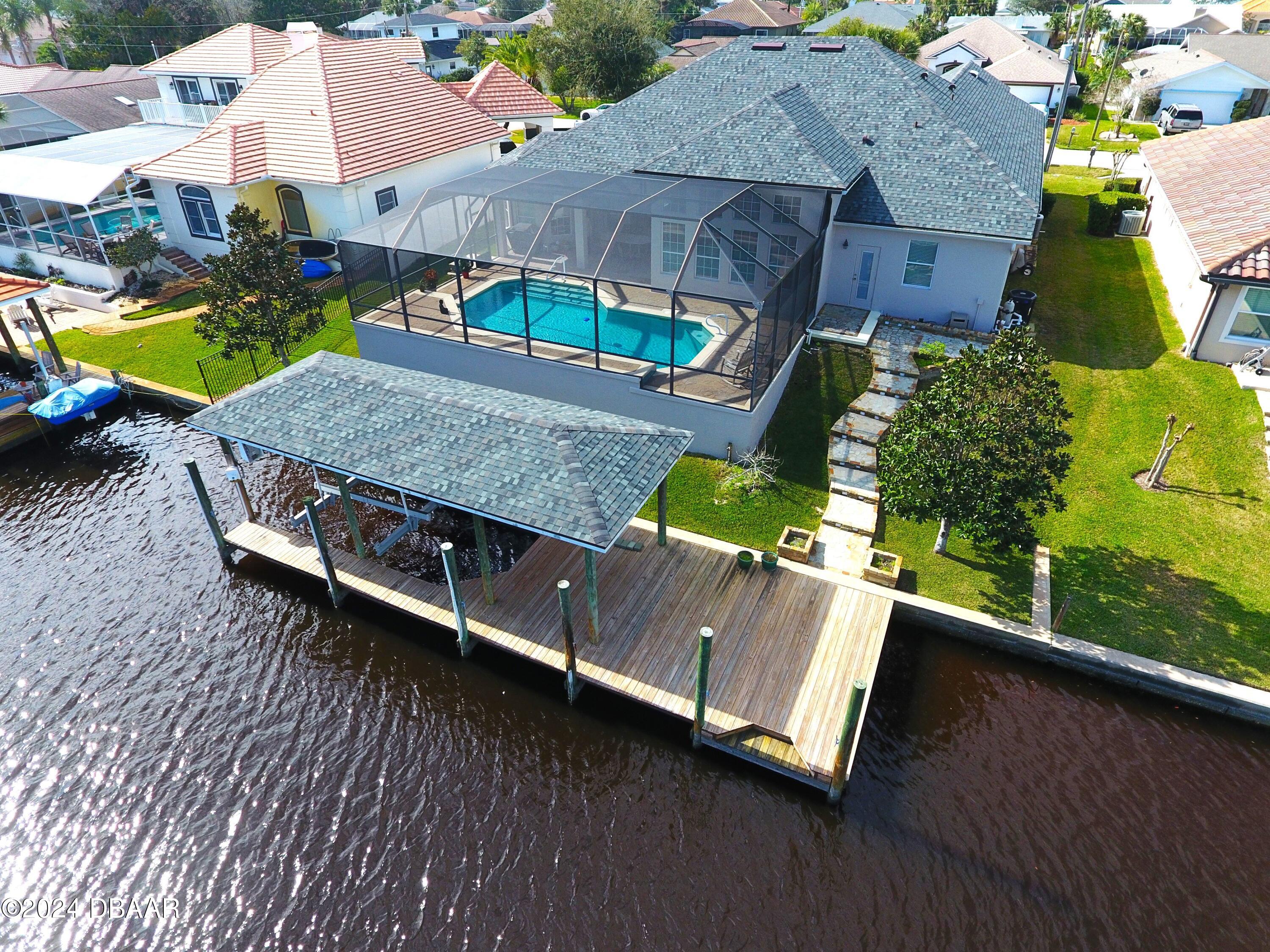 an aerial view of a house with a yard pool outdoor seating and yard