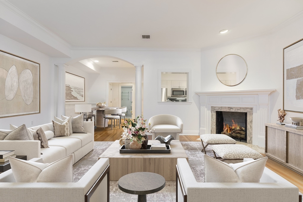 a living room with furniture a fireplace and a chandelier