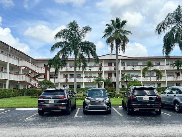 a car parked in front of a building and cars parked