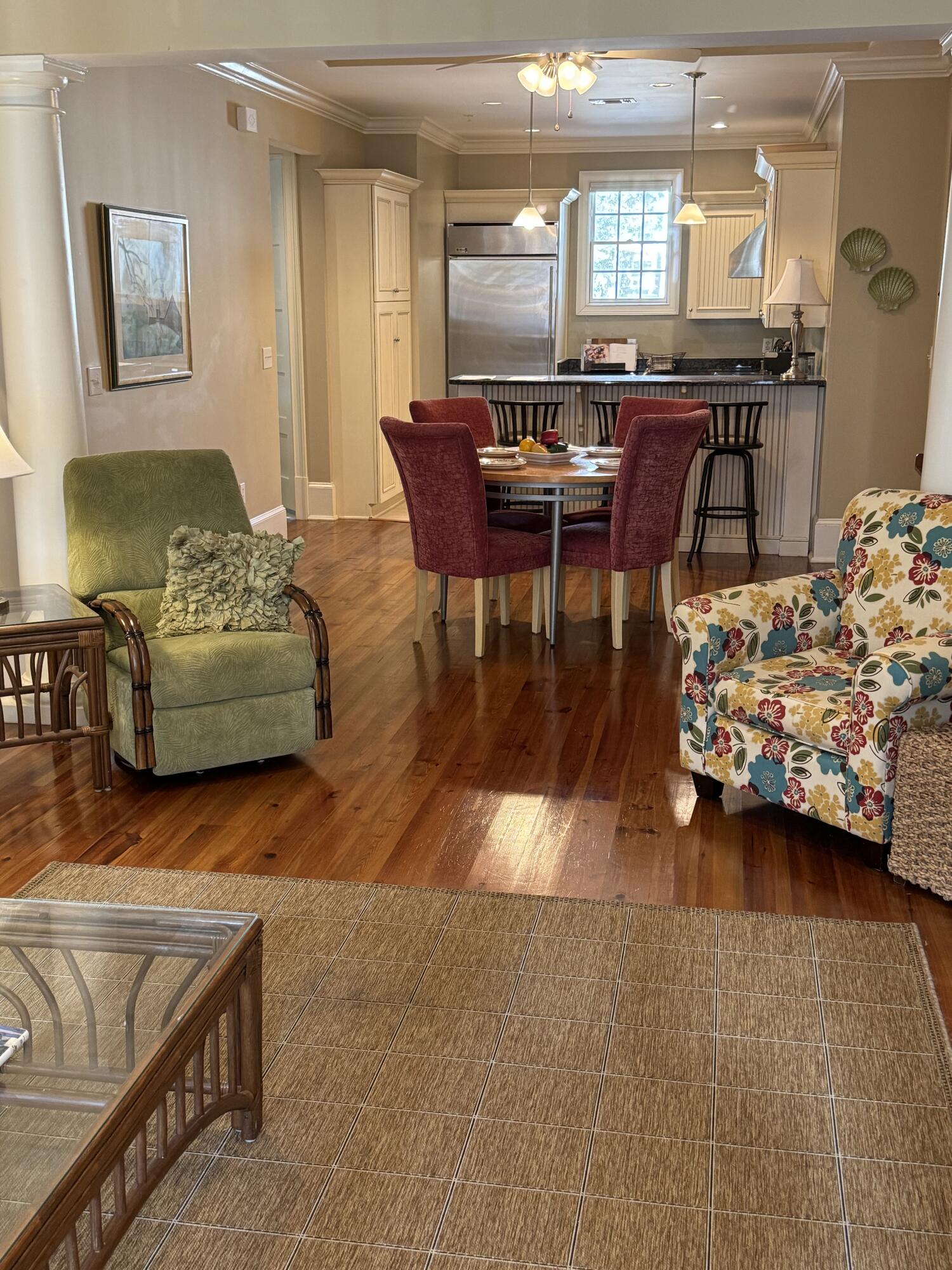 a dining room with furniture and wooden floor