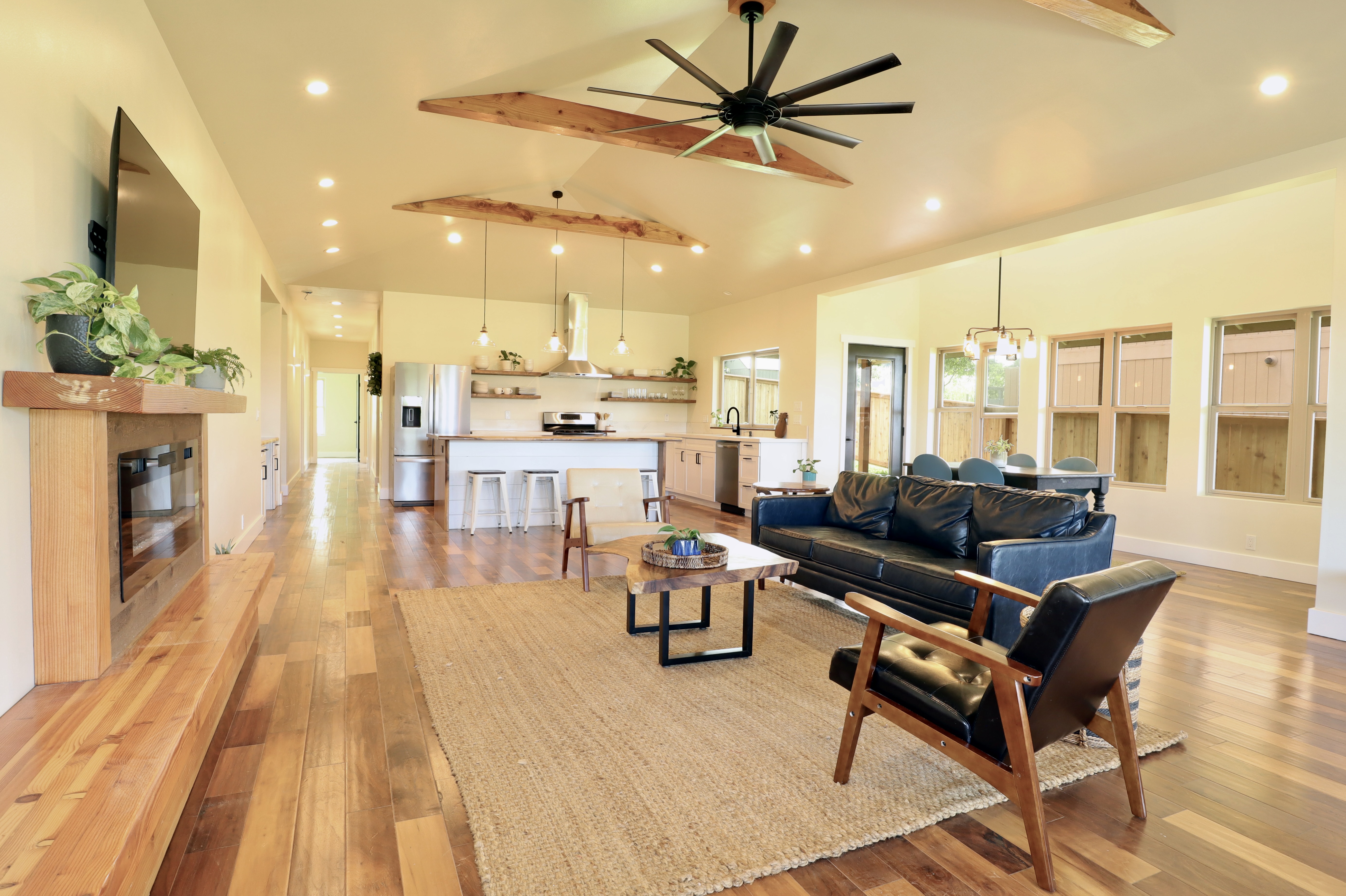 The open concept design includes a large living room, dining area and kitchen that includes two easy access doors to the large covered lanai.