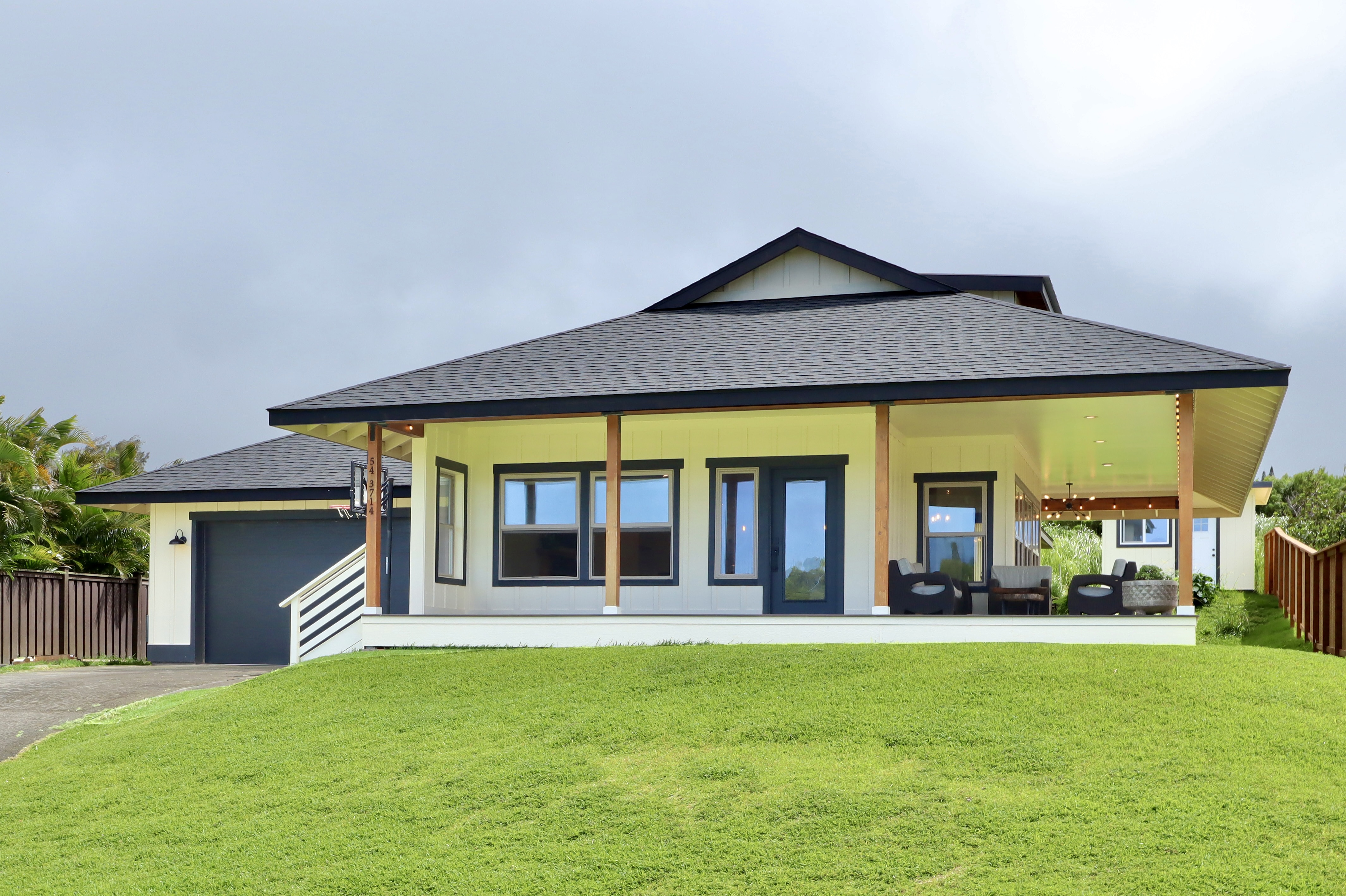 a front view of a house with a garden