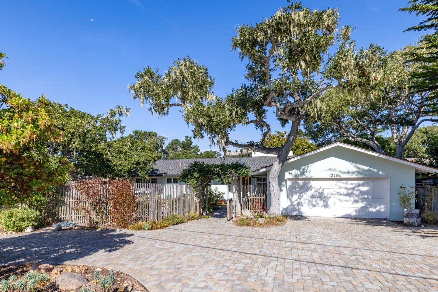 a view of a house with a tree and a yard