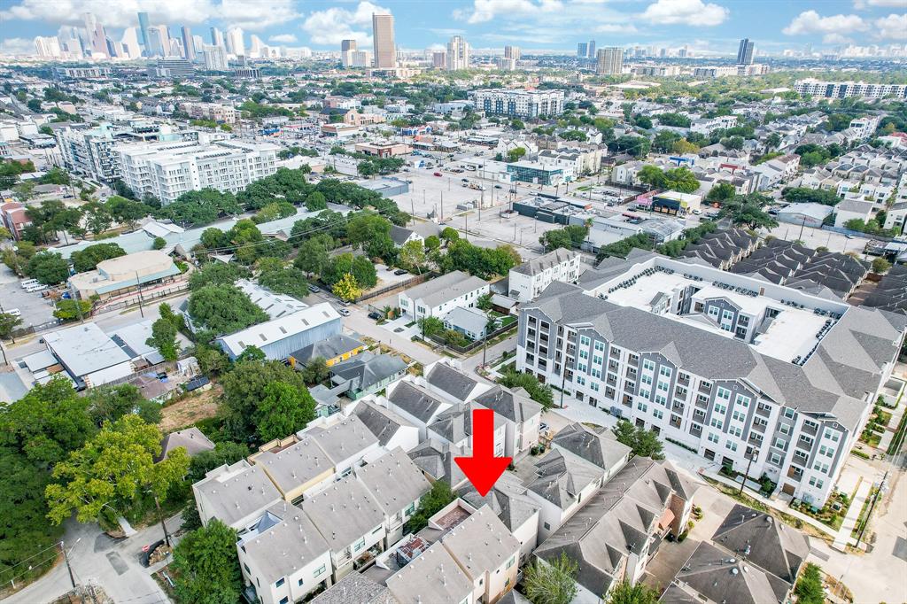 an aerial view of residential houses with city view