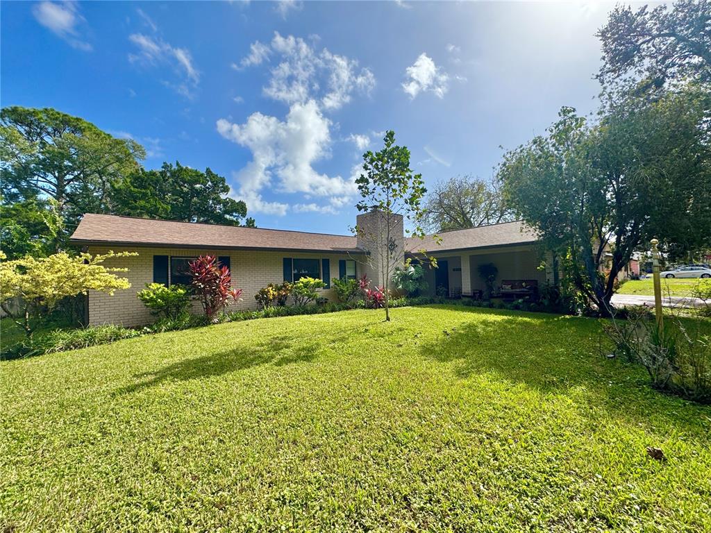 a front view of house with yard and green space