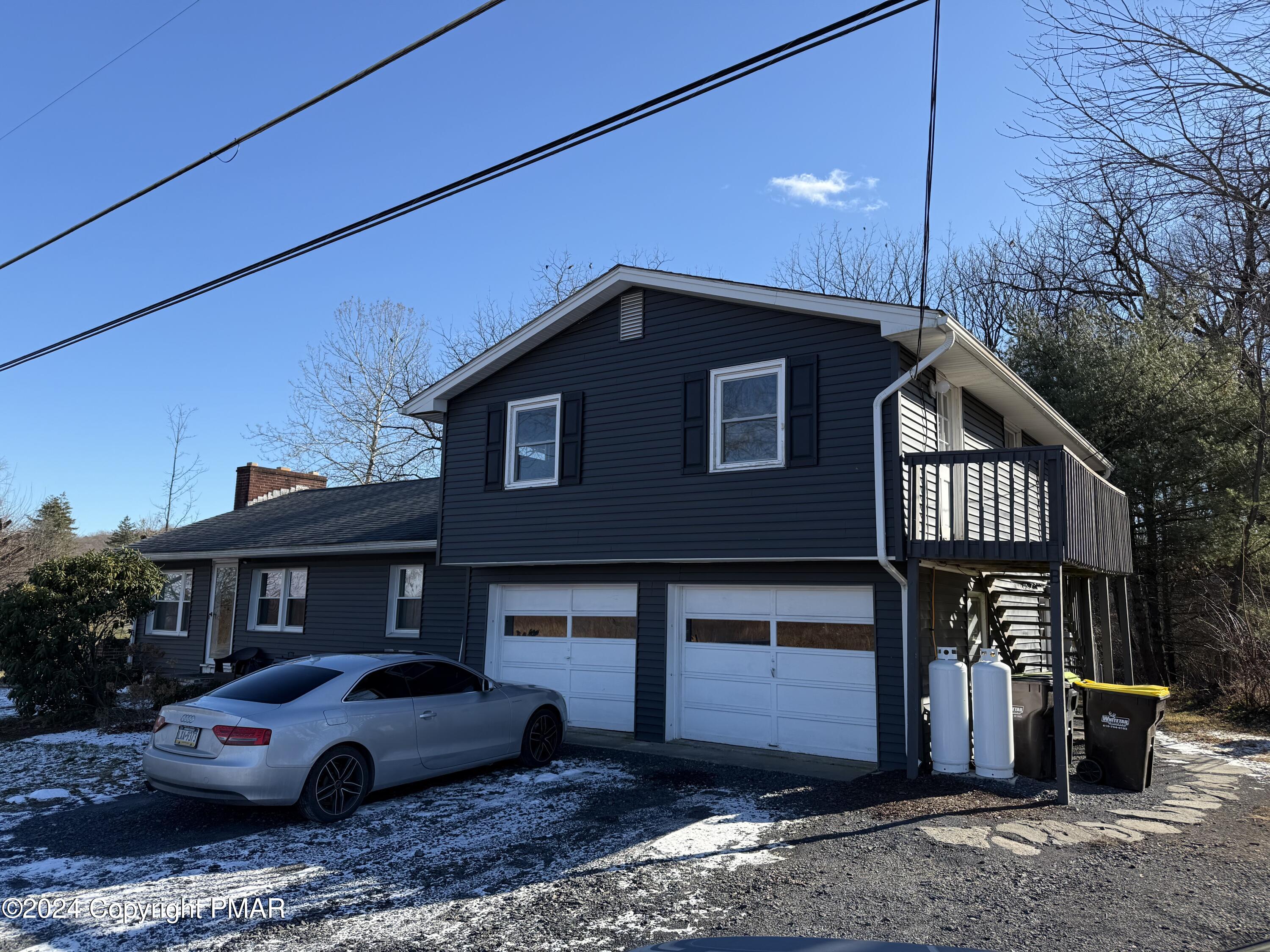 a front view of a house with parking space