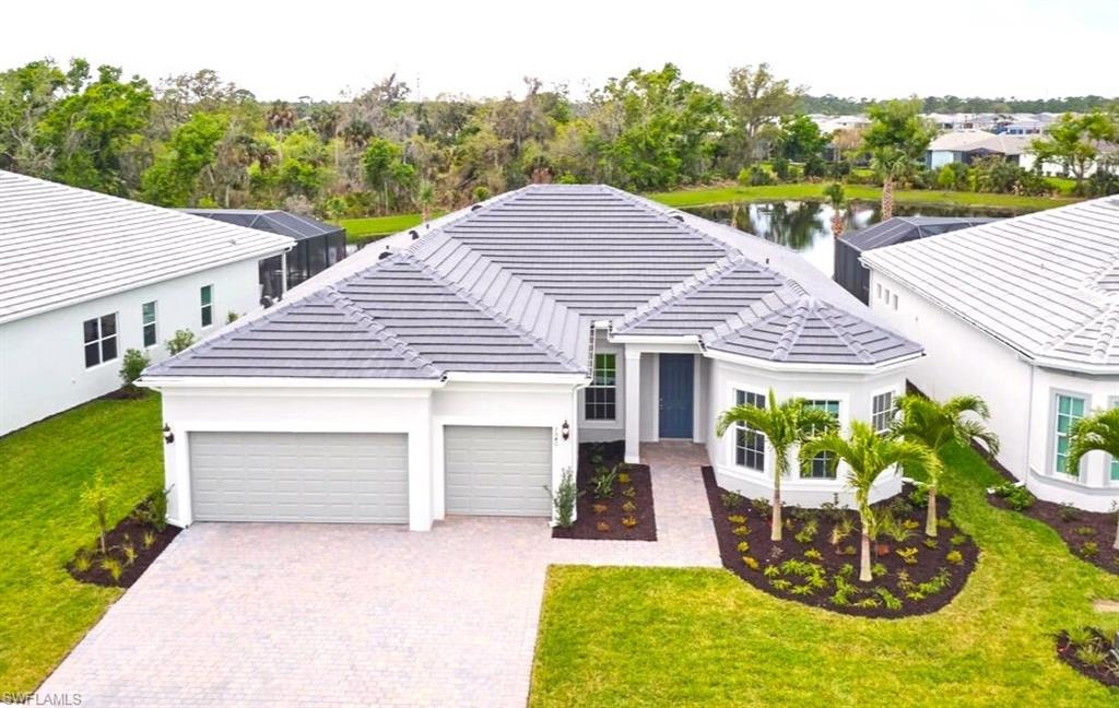 a view of a house with backyard and a garden