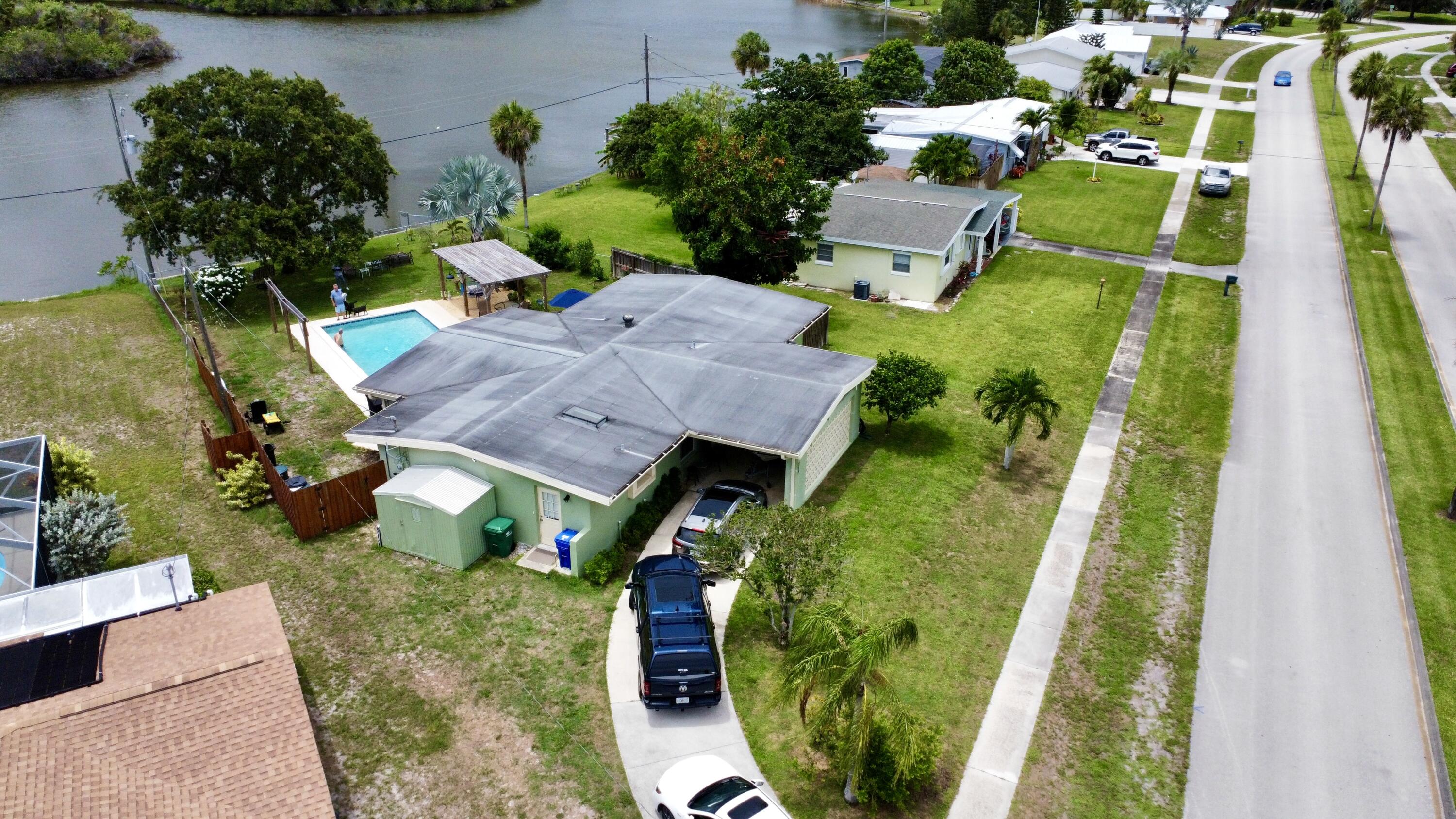 an aerial view of a house with a garden and lots of tress