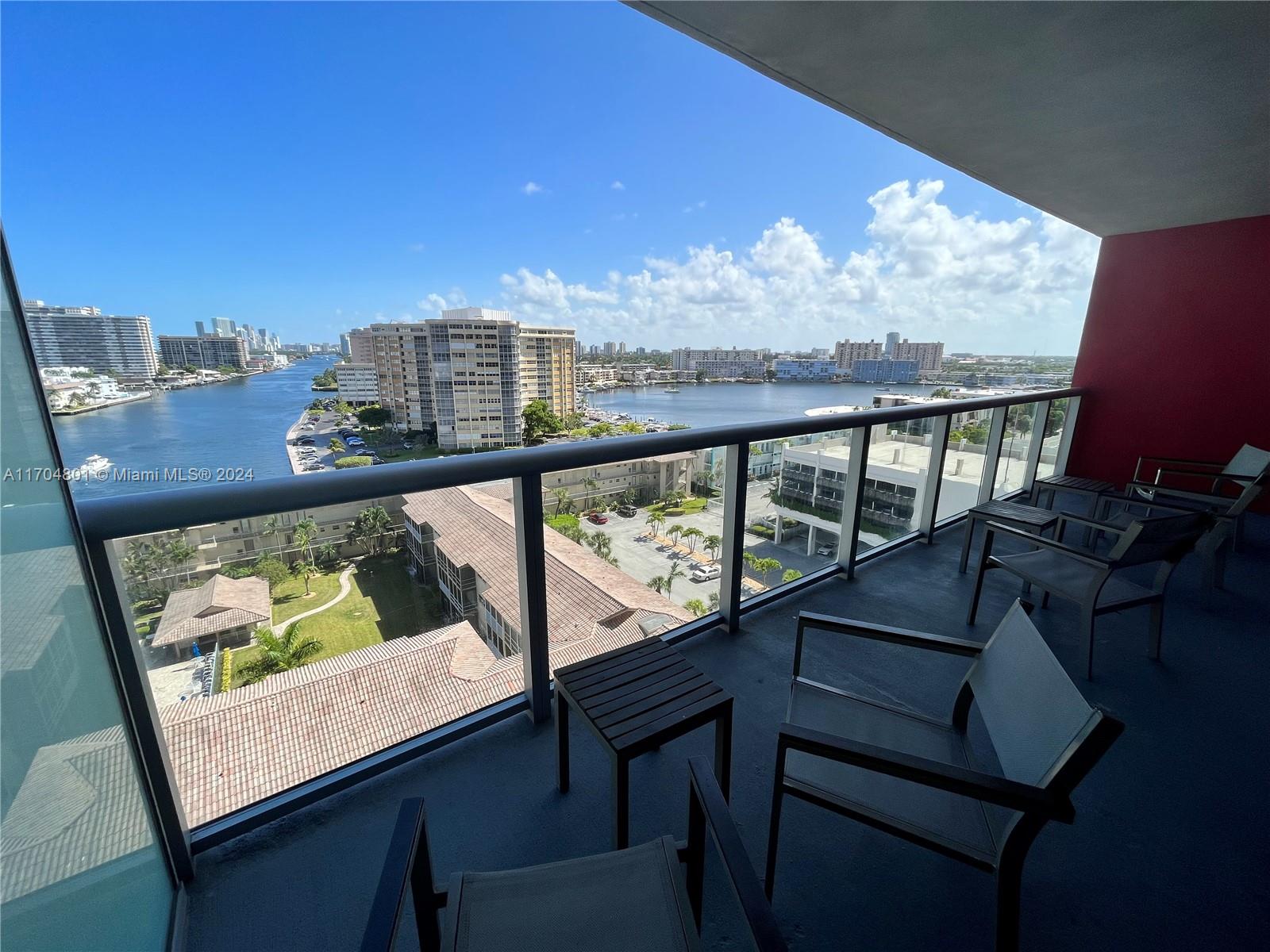 a view of a balcony with furniture and a ocean view