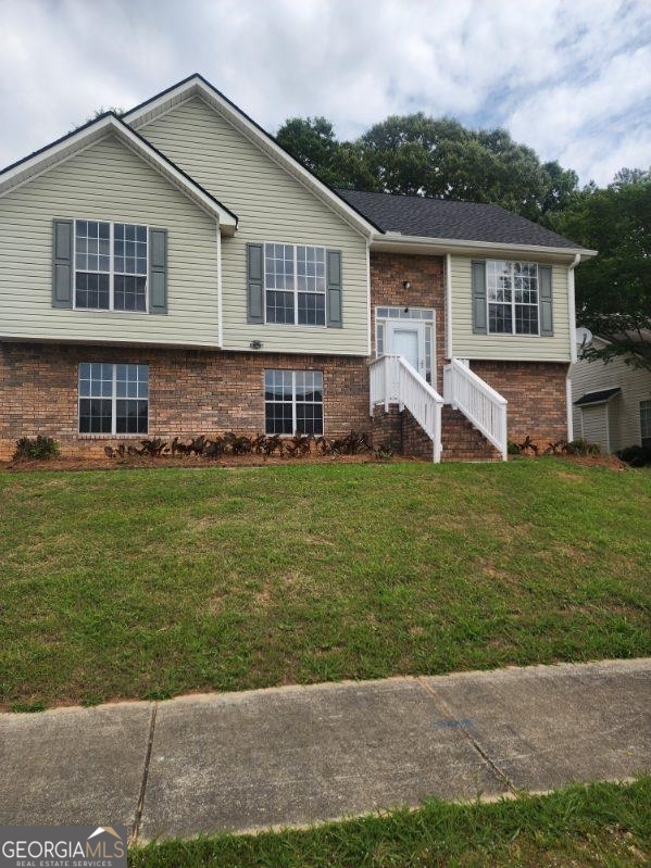 a front view of house with yard and green space