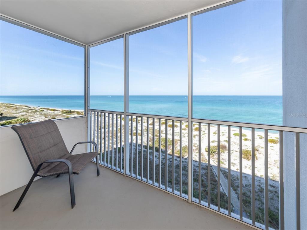 a view of a balcony with chair and table