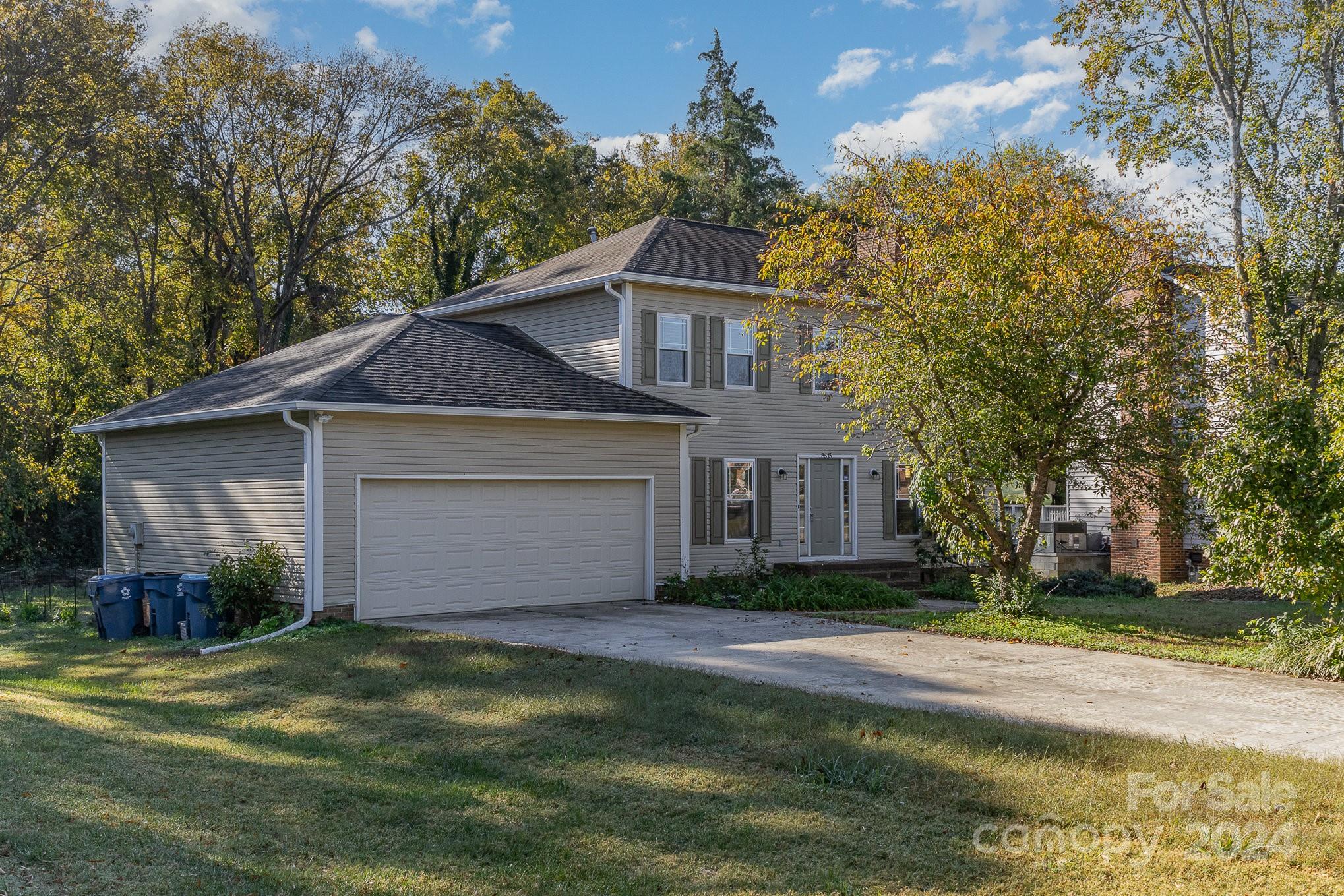 a front view of house with yard and trees