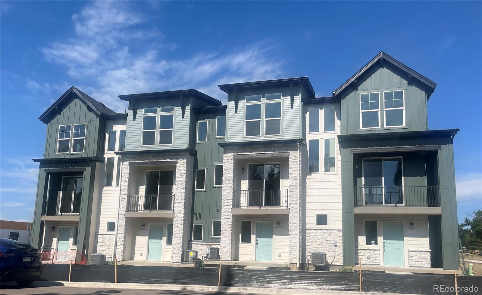 a front view of a residential apartment building with a yard