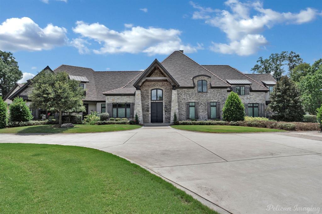 a front view of a house with a garden and yard