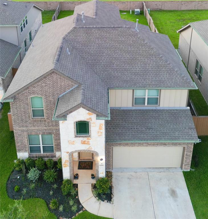 a aerial view of a house with a yard and potted plants