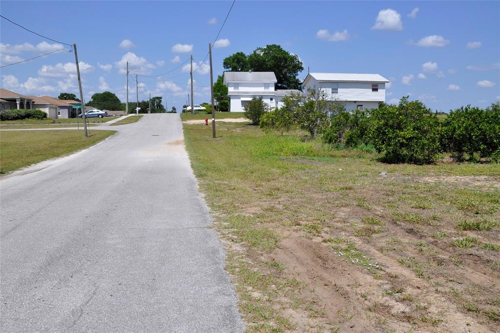 a view of a street with a building in the background