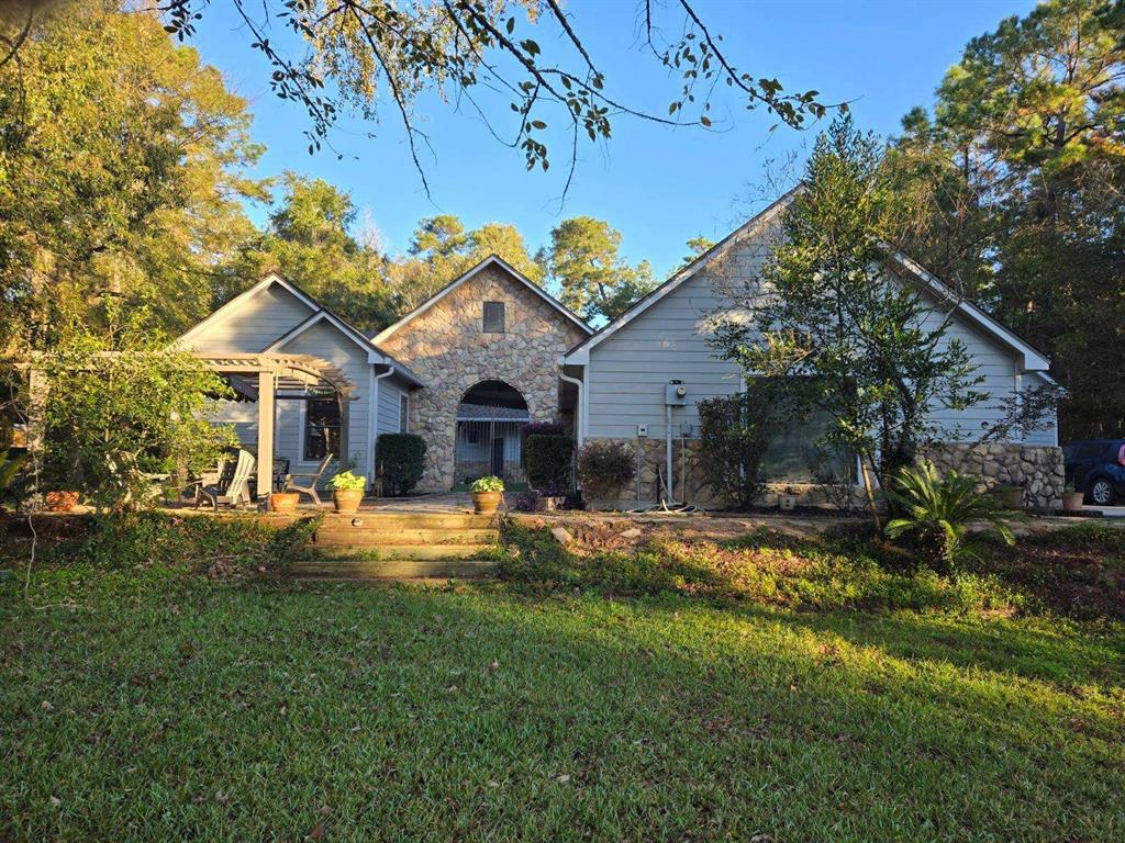 a front view of house with yard outdoor seating and green space