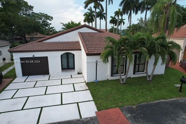 a view of house with palm tree and garden