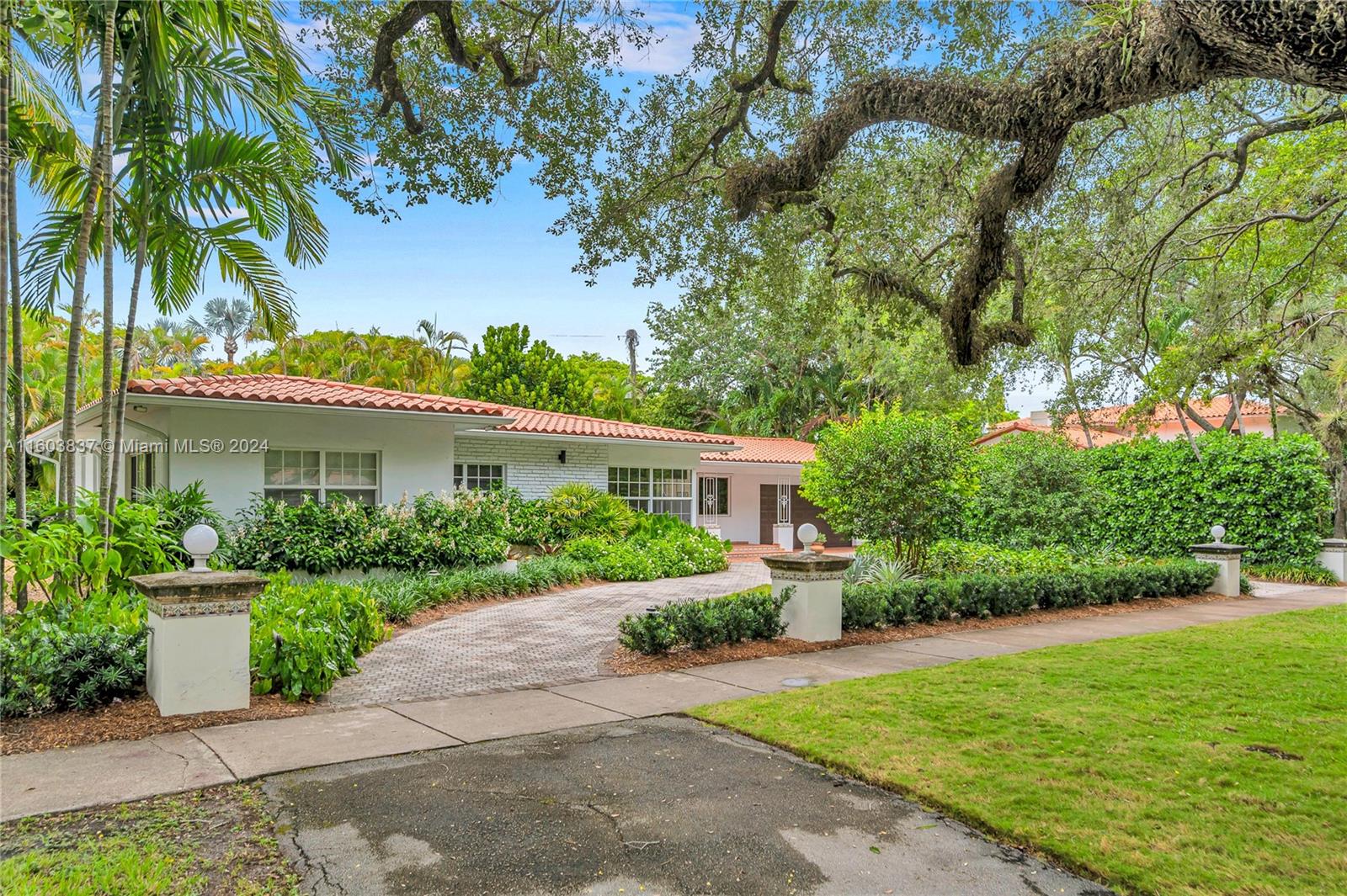 a front view of a house with a garden