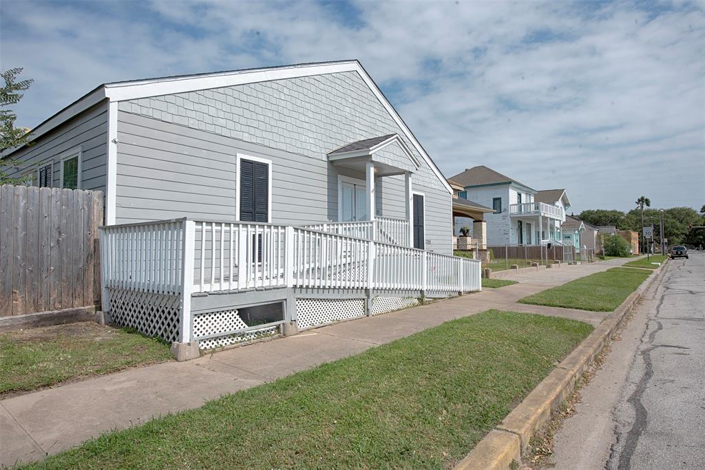 a view of house with a yard and sitting area