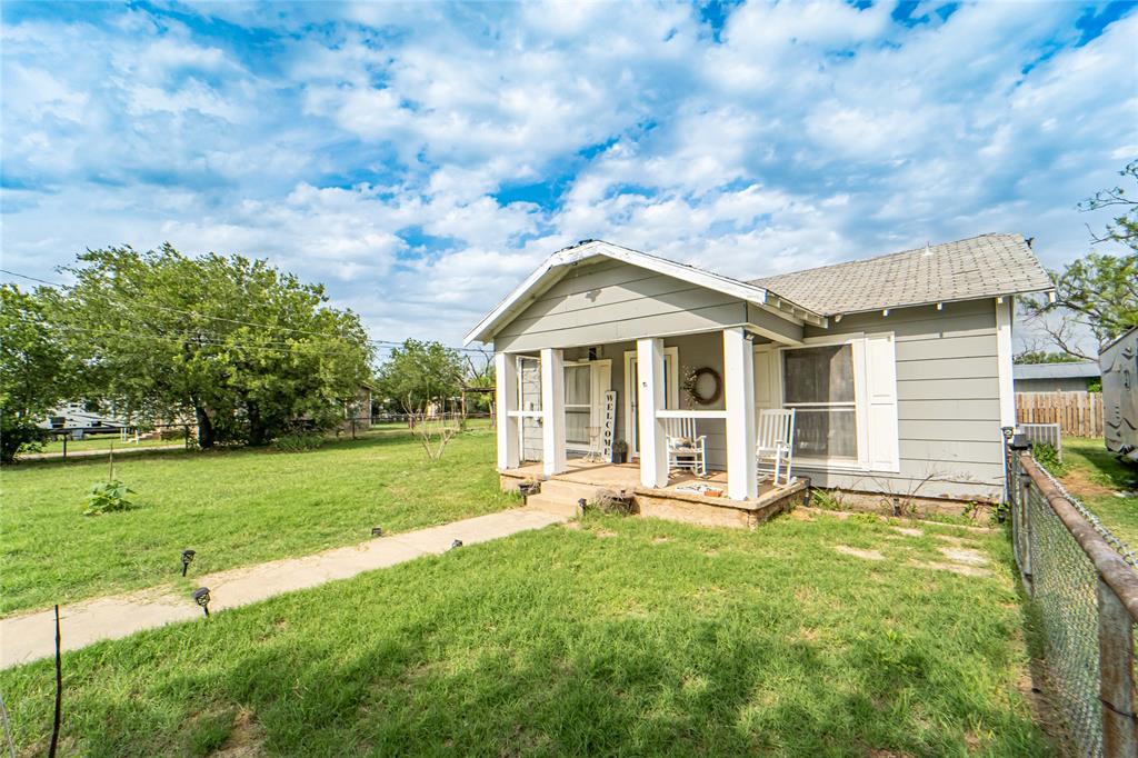 a front view of house with yard and seating area