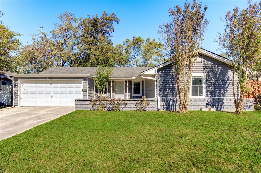 a front view of house with yard and outdoor seating