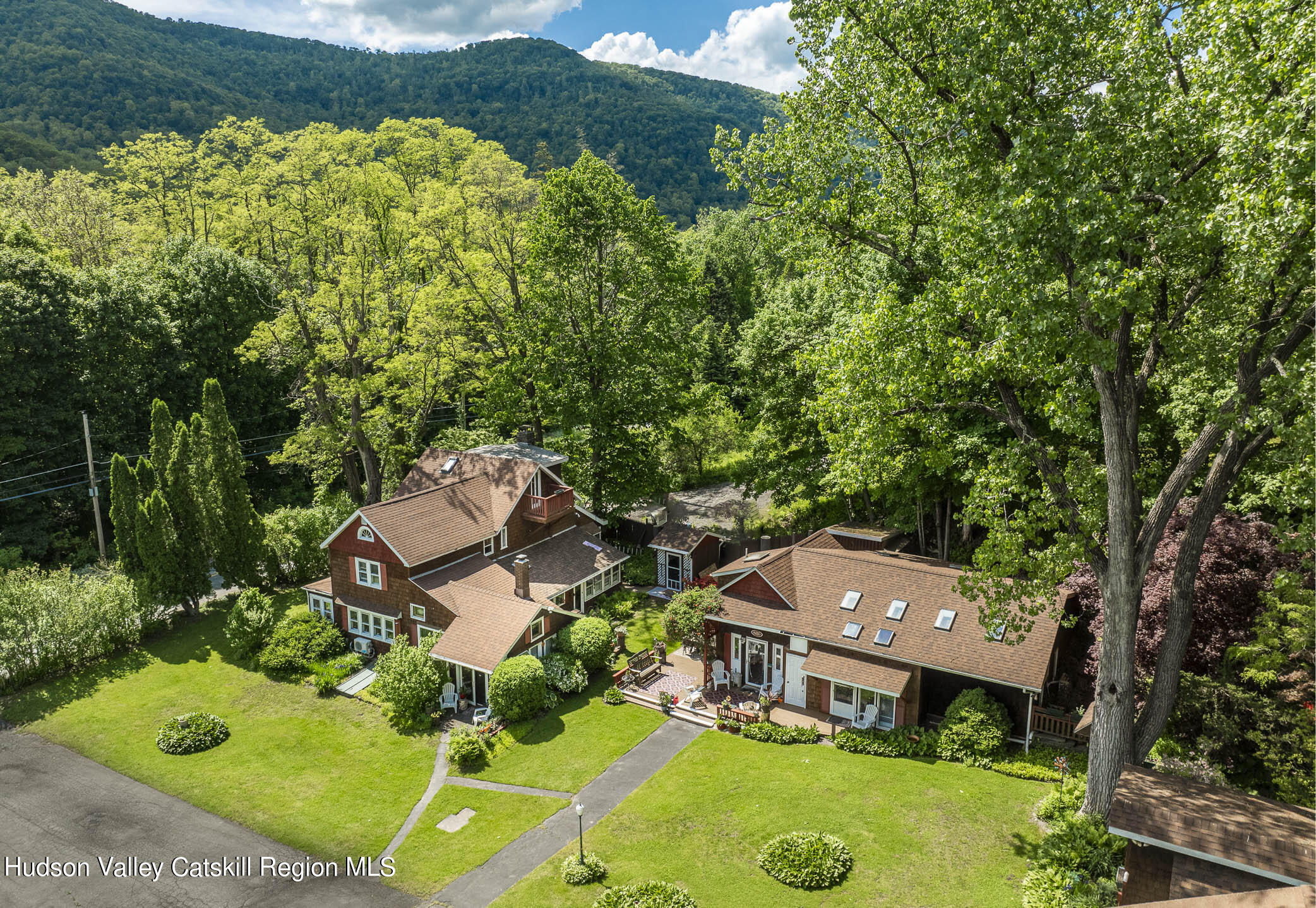 an aerial view of a house with yard swimming pool and outdoor seating