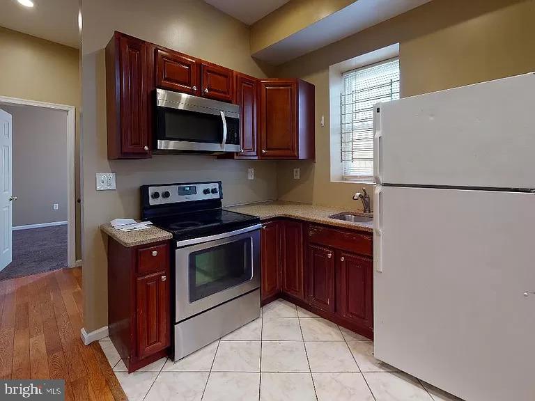 a kitchen with stainless steel appliances granite countertop a refrigerator stove a sink and dishwasher